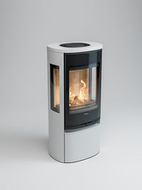 Side view of Contura 956G wood burning stove with glass door and side panels, showcasing flames and sleek design.