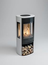 Side view of the Contura 956G wood burning stove with a sleek glass door and painted aluminium top, showcasing the flames.