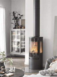Contura Connect 556G wood burning stove with glass door and side panels, showcasing its modern design and efficiency.