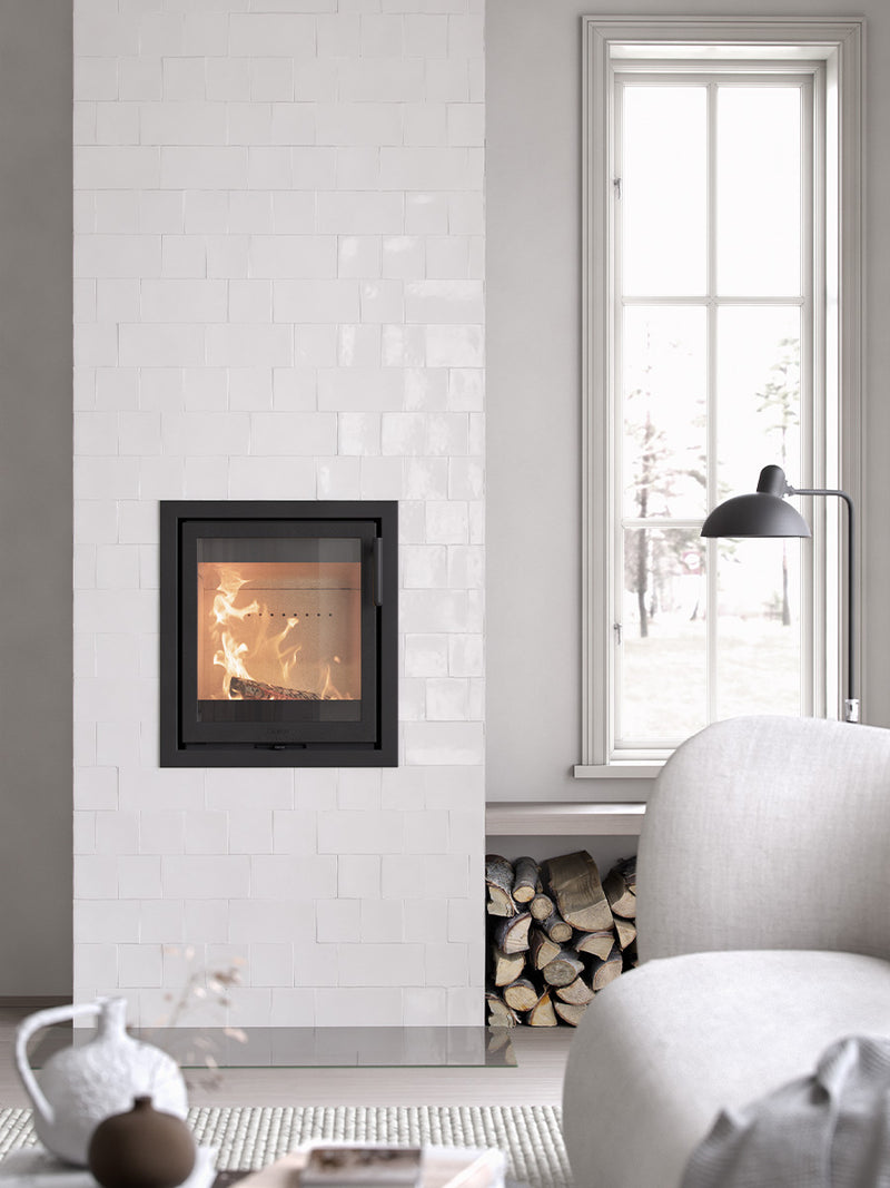Contura i2 wood burning fireplace insert with cast iron door, showcasing compact design and glass front for efficient heating.