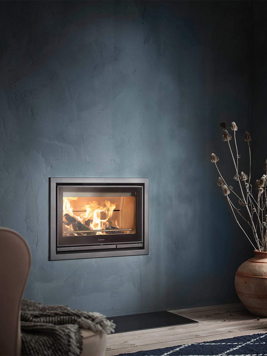 Contura i7 wood burning fireplace insert with cast iron door and steel frame, showcasing a sleek, modern design.