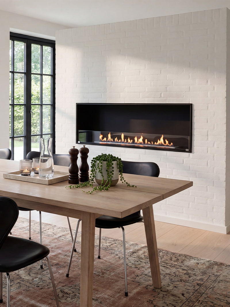 Side view of the Decoflame Montreal 1200mm bioethanol fireplace showcasing the sleek glass panel and flames.