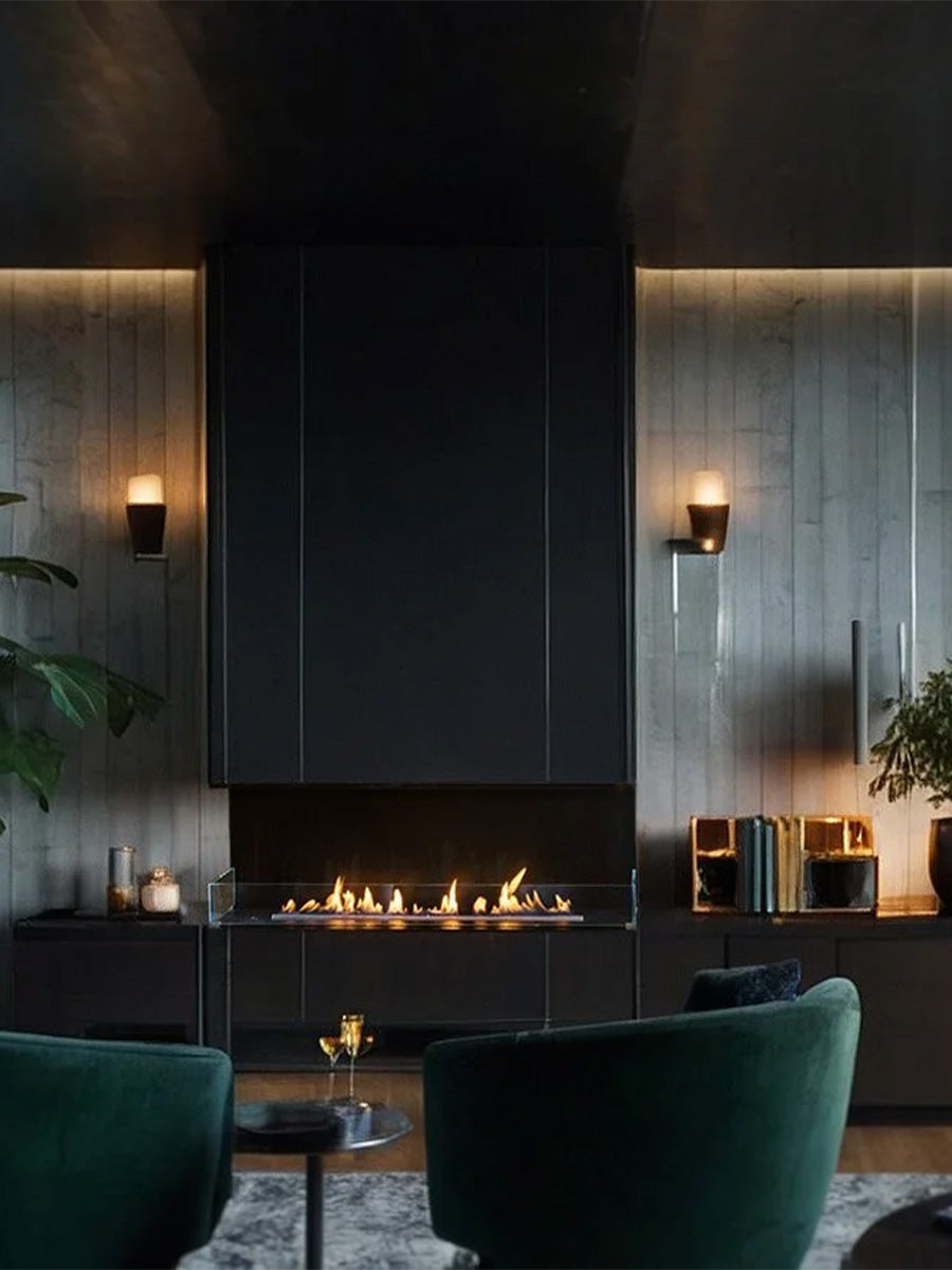 Three-sided glass bioethanol fireplace with a sleek black frame, showcasing a vibrant flame from multiple angles.