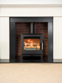 Side view of Heta Ambition 5 wood burning stove with cast iron door and large glass for flame visibility.