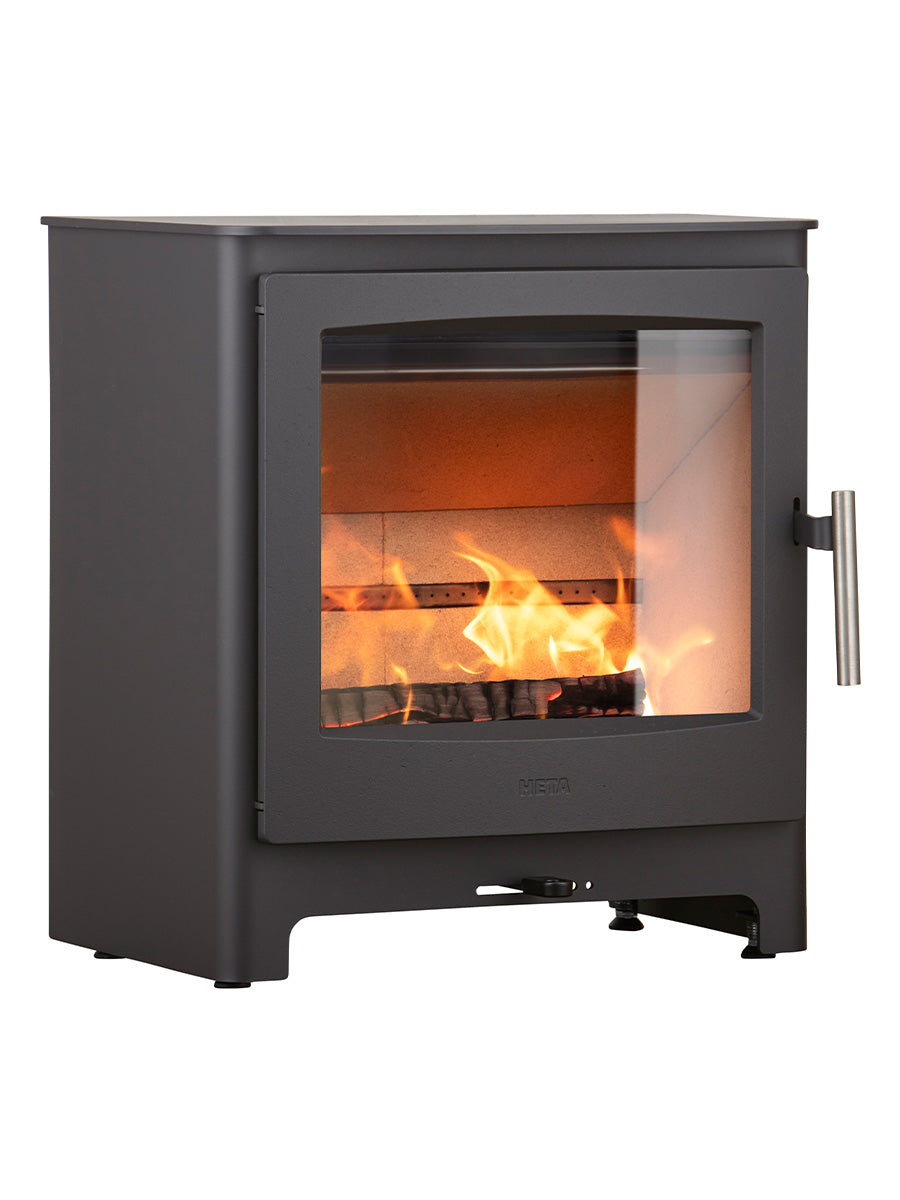 Heta Ambition 8 wood burning stove with cast iron door, wide combustion chamber, and log store base in a stylish setting.