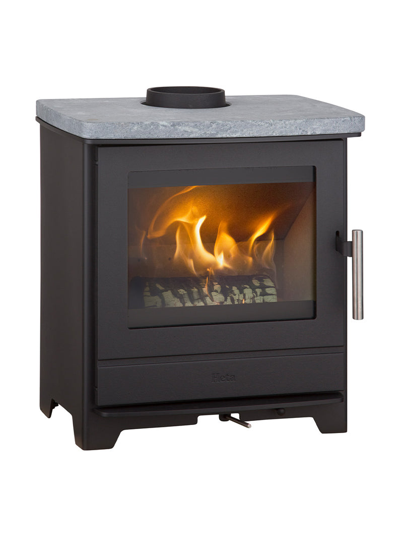Compact Heta Inspire 45 wood burning stove in black steel with a cast iron door, showcasing its modern design and rugged build.