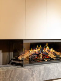 Side view of Kalfire E-One 130C corner electric fire showcasing holographic flames and ceramic logs in a sleek design.