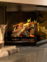 Side view of Kalfire E-One 130C corner electric fire with glass panels, showcasing dual HD flames and ceramic logs.