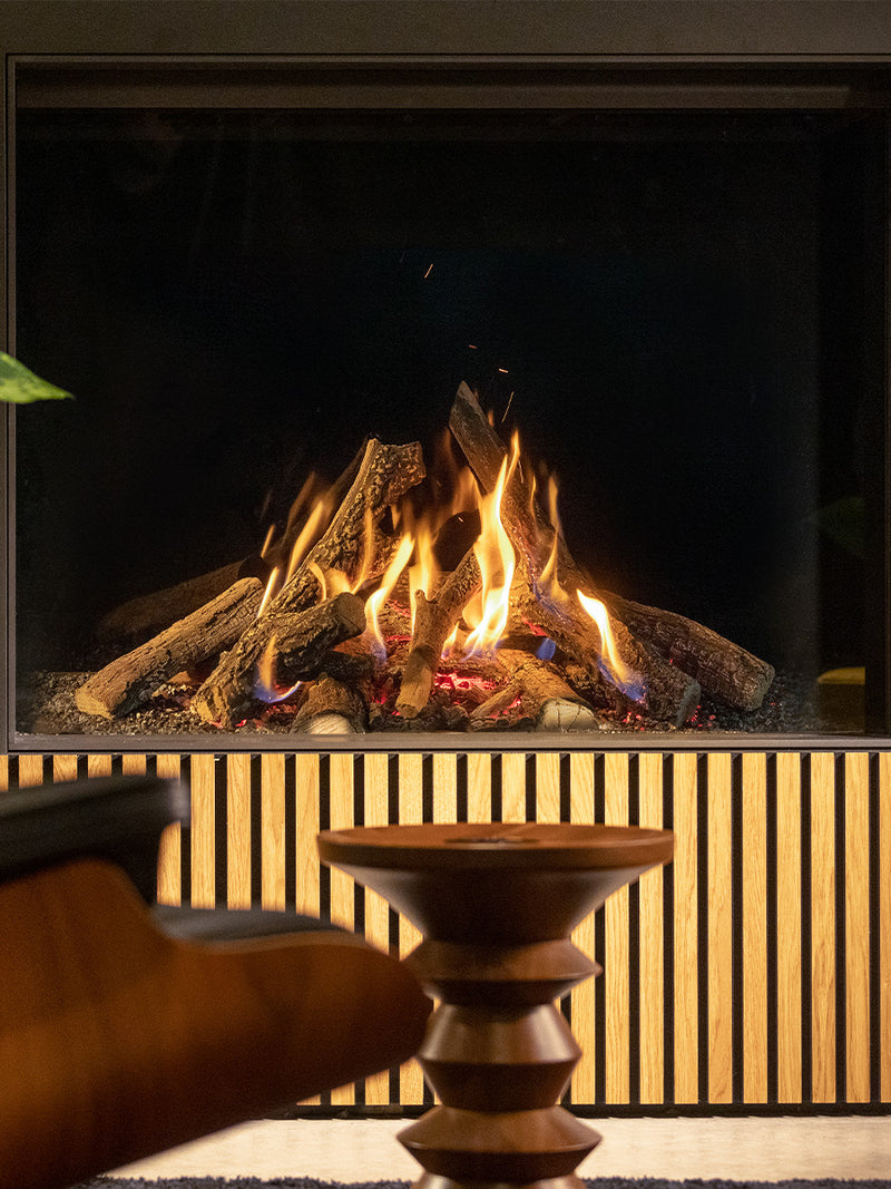 Front view of Kalfire Gi105/59F gas fireplace with sleek black finish and LED ember bed, showcasing modern design.