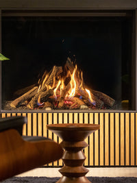 Side view of Kalfire Gi105/79F gas fireplace with sleek black frame and large glass window showcasing vibrant flames.