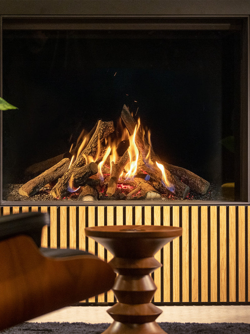 Side view of Kalfire Gi105/79F gas fireplace with sleek black frame and large glass window showcasing vibrant flames.