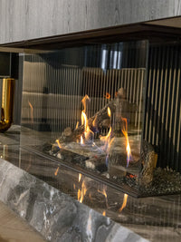 Side view of Kalfire Gi115/55S three-sided gas fireplace with dynamic flames and sleek black frame.