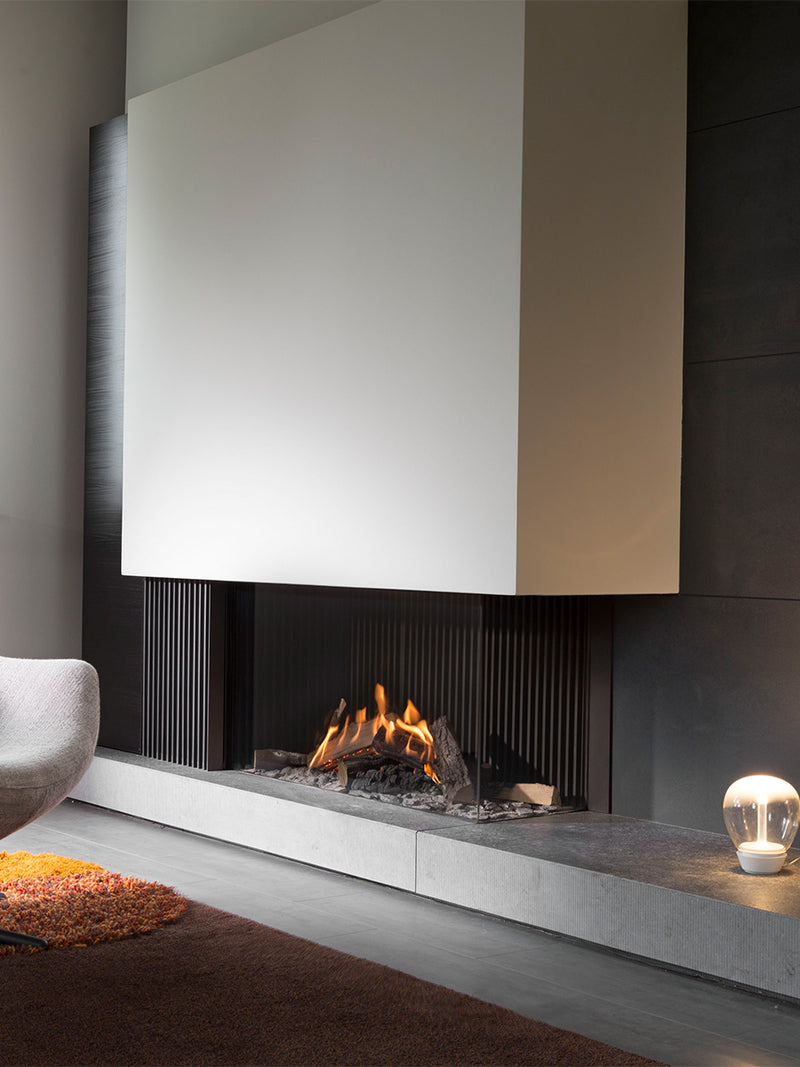 Side view of Kalfire GP110/55C gas fire in a corner setting, showcasing glass front and flame effects.