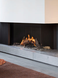 Side view of Kalfire GP110/55C gas fire, showcasing glass front and flame effects in a modern corner setting.