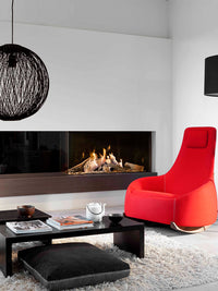 Side view of Kalfire GP110/55C gas fire in a corner, showcasing the glass front and flame effects in a modern setting.