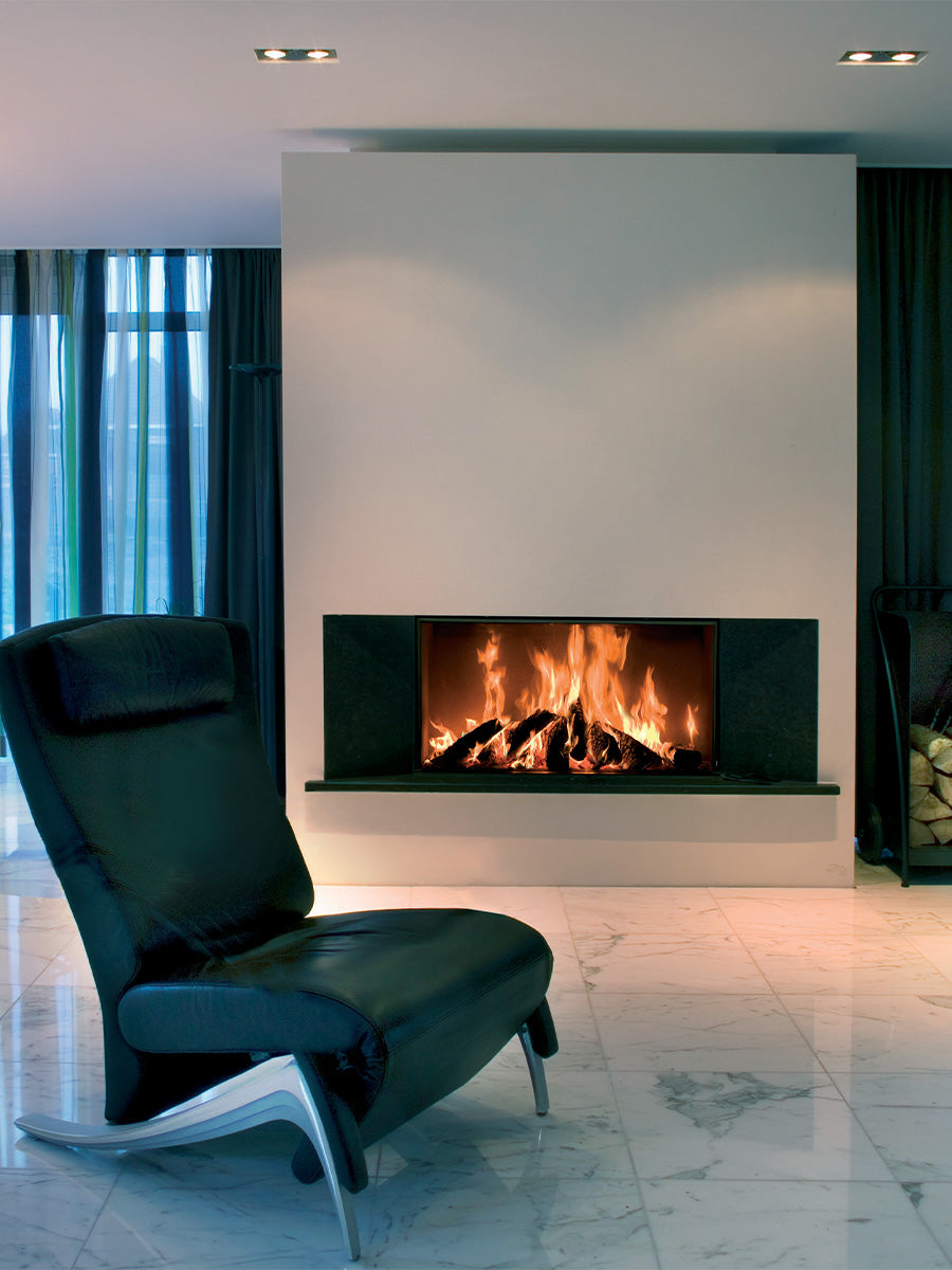 Front view of Kalfire W105/47F log burner fireplace with large glass panel and sleek black finish, set in a modern interior.