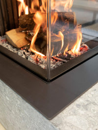 Side view of Kalfire W53/50R log burner fireplace with curved glass, showcasing its modern design and warm ambiance.