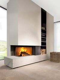 Side view of Kalfire W65/38C corner wood burner fireplace with curved glass and sleek design in a modern setting.