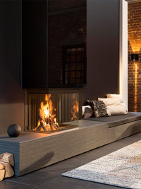 Side view of Kalfire W66/48S three-sided log burner fireplace with curved ceramic glass and warm flames.