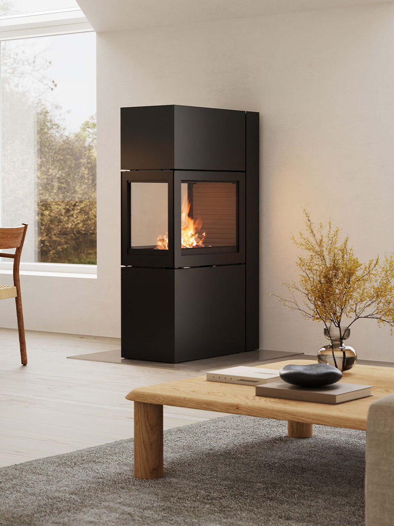 RAIS 600 Max RD wood burning stove in sleek black steel with a round design and large glass door, front view.