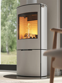 Side view of the RAIS Caro 110 wood burning stove with a glass door, showcasing its rounded design and elegant silhouette.