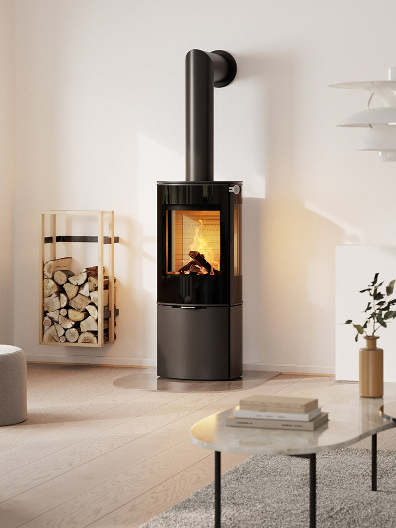 Side view of the RAIS Caro 110 wood burning stove with a glass door, showcasing its rounded design and elegant silhouette.