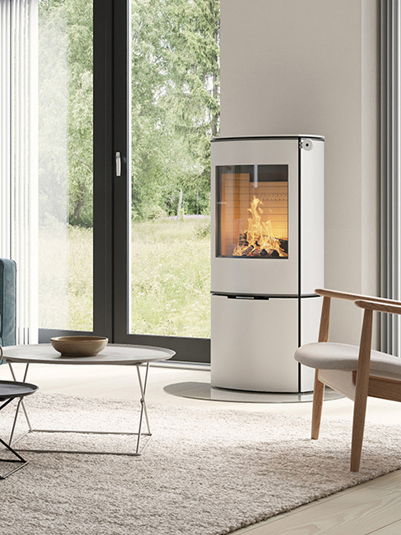 Side view of the RAIS Caro 110 wood burning stove with a glass door, showcasing its rounded design and elegant silhouette.