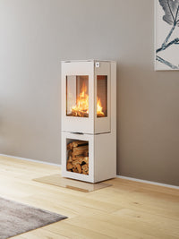 Side view of the RAIS Nexo 120 wood burning stove, showcasing its sleek design and large glass door.