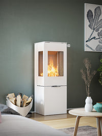 Side view of the RAIS Nexo 120 wood burning stove with a glass door, showcasing its sleek design and large glass panes.