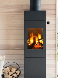 Side view of the RAIS Nexo 140 wood burning stove with a glass door, showcasing its sleek design and large glass panes.