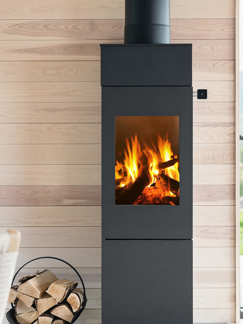 Side view of the RAIS Nexo 140 wood burning stove with a glass door, showcasing its sleek design and large glass panes.