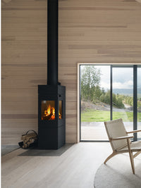 Side view of RAIS Nexo 140 wood burning stove with glass door, showcasing sleek design and large glass panes.