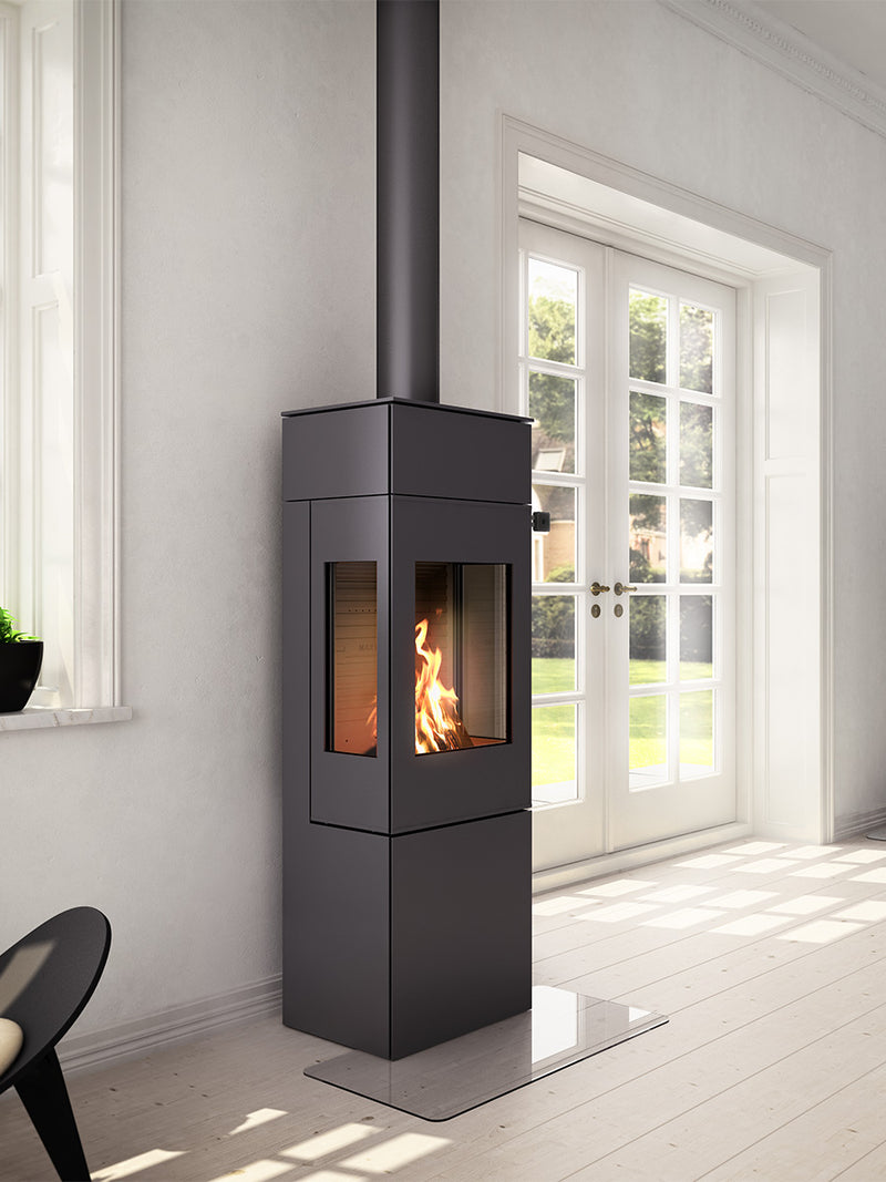 Elegant RAIS Nexo 140 wood burning stove with glass door, showcasing smooth surfaces and geometric design, side view.