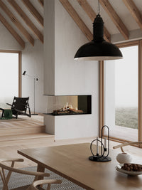 Modern RAIS Visio 100 RD gas fireplace insert with three glass sides, showcasing flames, used as a stylish room divider.