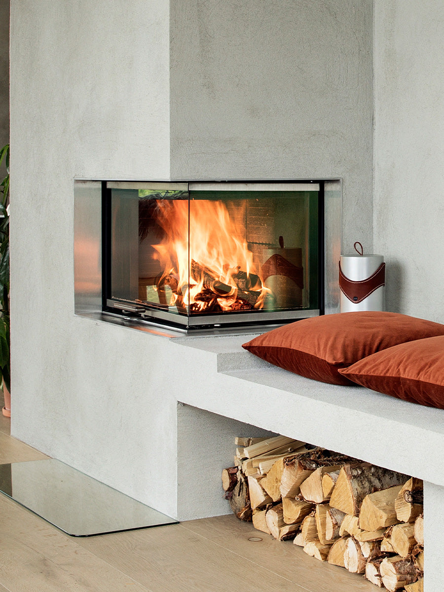 RAIS Visio 2 wood burning stove corner with glass sides, showcasing sleek design and natural wood finish.
