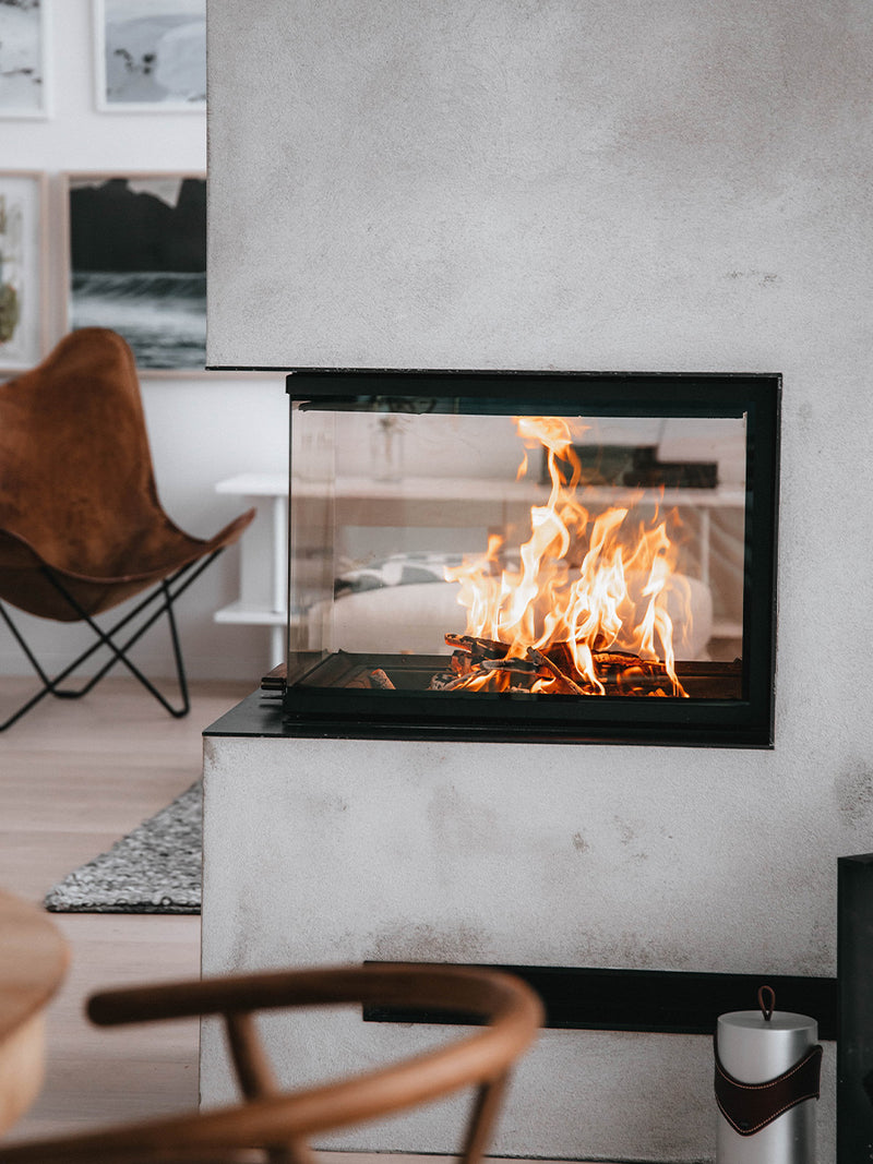 Side view of RAIS Visio 3:1 wood burning stove room divider, showcasing glass panels and elegant design.