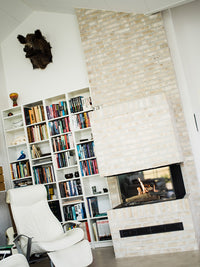 Three-sided gas fireplace insert with black frame, showcasing realistic flames and sleek design.