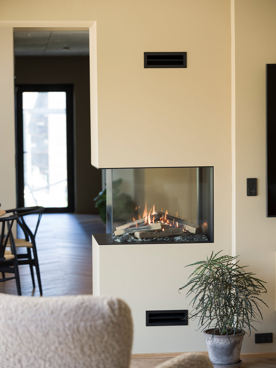 RAIS Visio 70 RD gas fireplace insert room divider with two glass fronts, showcasing a sleek black design.