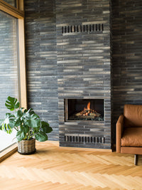 Front view of RAIS Visio 70 F gas fireplace insert with black frame, showcasing flames behind non-reflective glass.