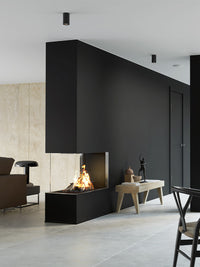 Side view of RAIS Visio 90 RD gas fireplace insert with glass fronts and black frame, showcasing the flames.