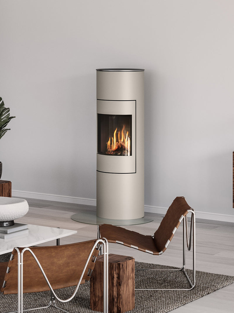 Round RAIS Viva L 140 gas fire stove with a glass door, showcasing steady flames and elegant design in a cozy setting.
