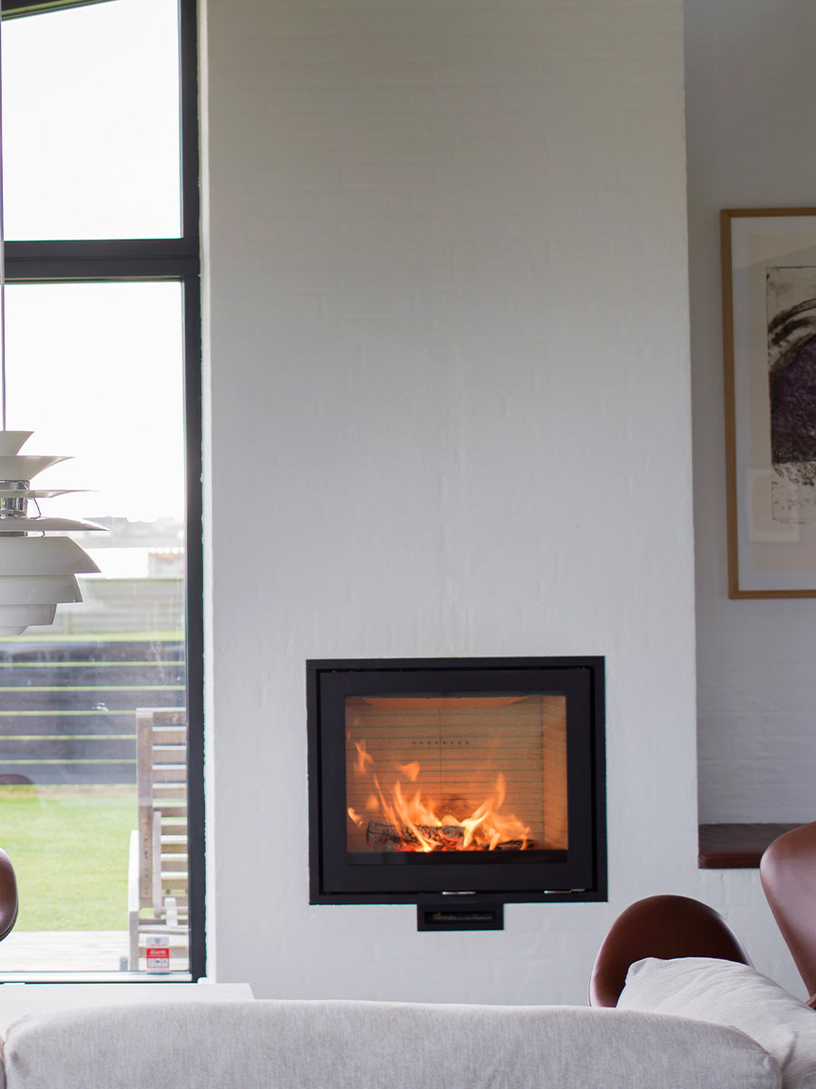 Front view of Rais 600 1 inset wood burning stove with large glass panes and sleek steel frame.
