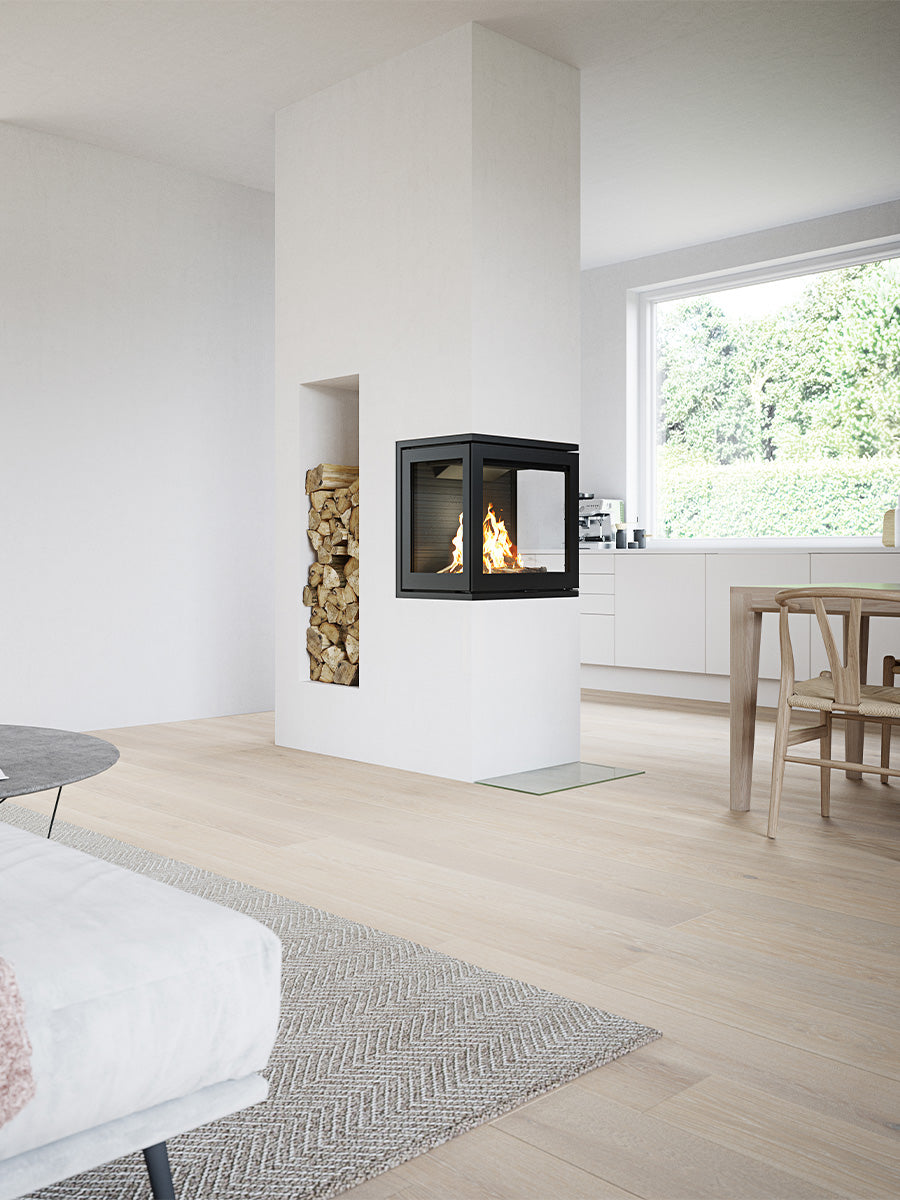 Three-sided wood burning stove with large glass panes showcasing flames and elegant cube-shaped design in black finish.